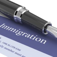 Immigration document with pen on top