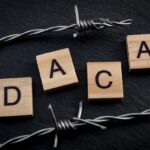 Deferred action for child arrivals concept with barb wire next to letters that spell the acronym DACA. DACA is a piece of legislation that protects immigrants that were brought to the USA as children Deferred action for child arrivals concept with barb wire next to letters that spell the acronym DACA. DACA is a piece of legislation that protects immigrants that were brought to the USA as children