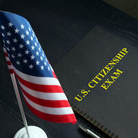 US citizenship exam test and USA flag.