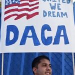 DACA sign above immigrant DACA sign above immigrant